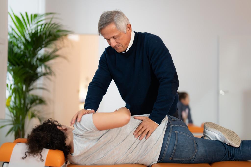 Tonovital Centro Quiropractico Ajuste de Lumbares 3 José De San Juan Guerrero trabajando la zona lumbar de una paciente en camilla en Tonovital Centro Quiropráctico Málaga